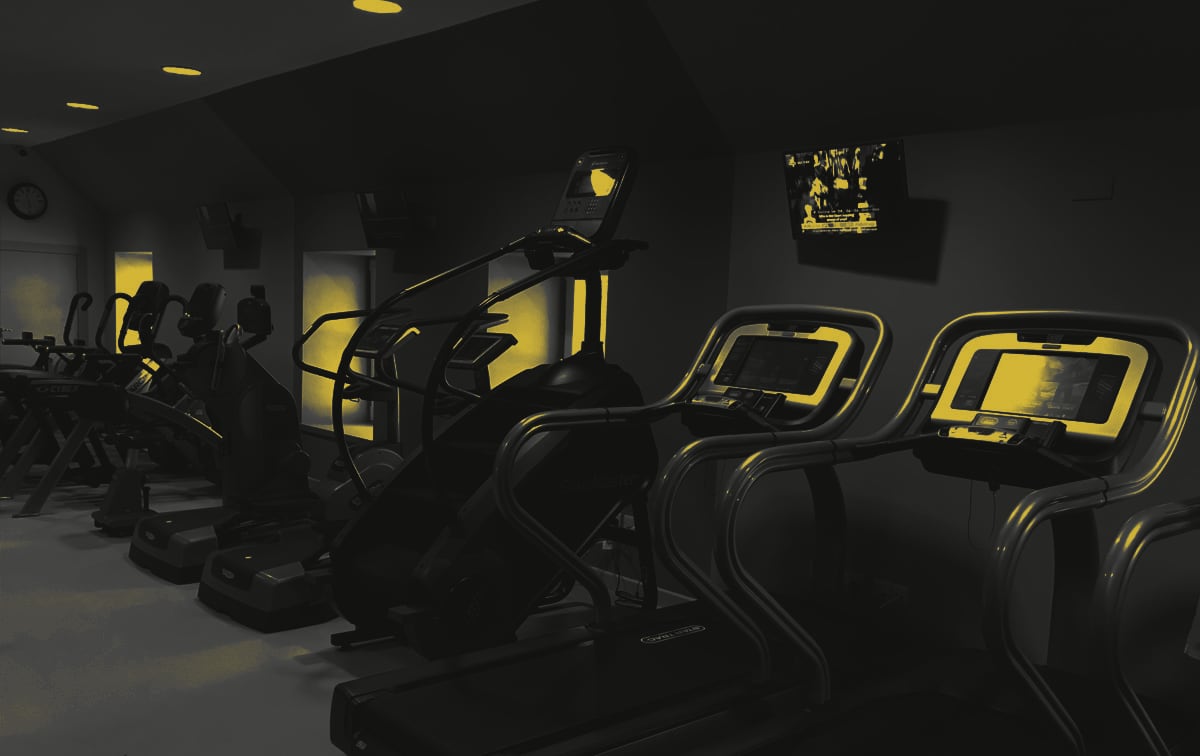 Treadmills, a stair climber and cross-trainers under the TVs