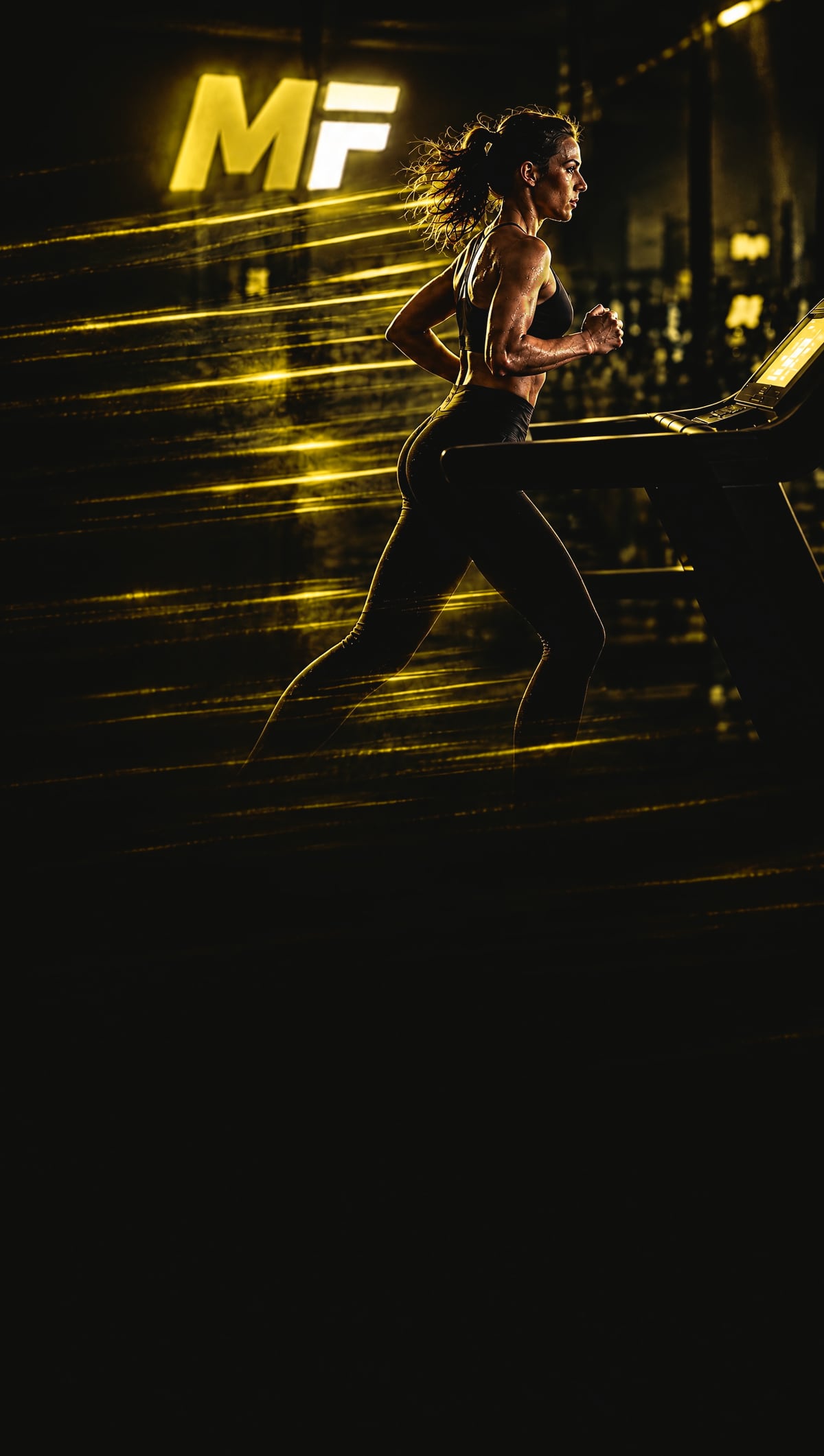 A woman running on a treadmill in the dark, streaks of gold light behind her